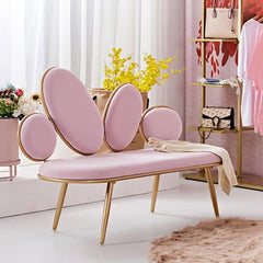 Pink butterfly-shaped bench in a stylish room with decor elements.