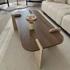 Modern coffee table in a living room setting with a sofa and rug.