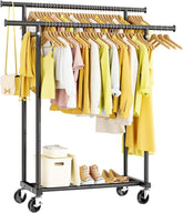 Clothing rack with clothes and shoes on wheels against a white background