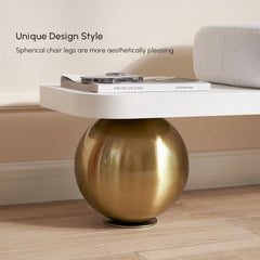 Modern chair with spherical gold legs on a wooden floor