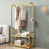 Gold clothing rack with clothes and shoes in a room setting