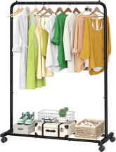 Clothing rack with clothes and shoes on a white background