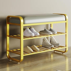 Yellow shoe rack with a cushioned bench holding various shoes on a wooden floor.