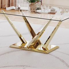 Glass dining table with gold metal legs on a white rug