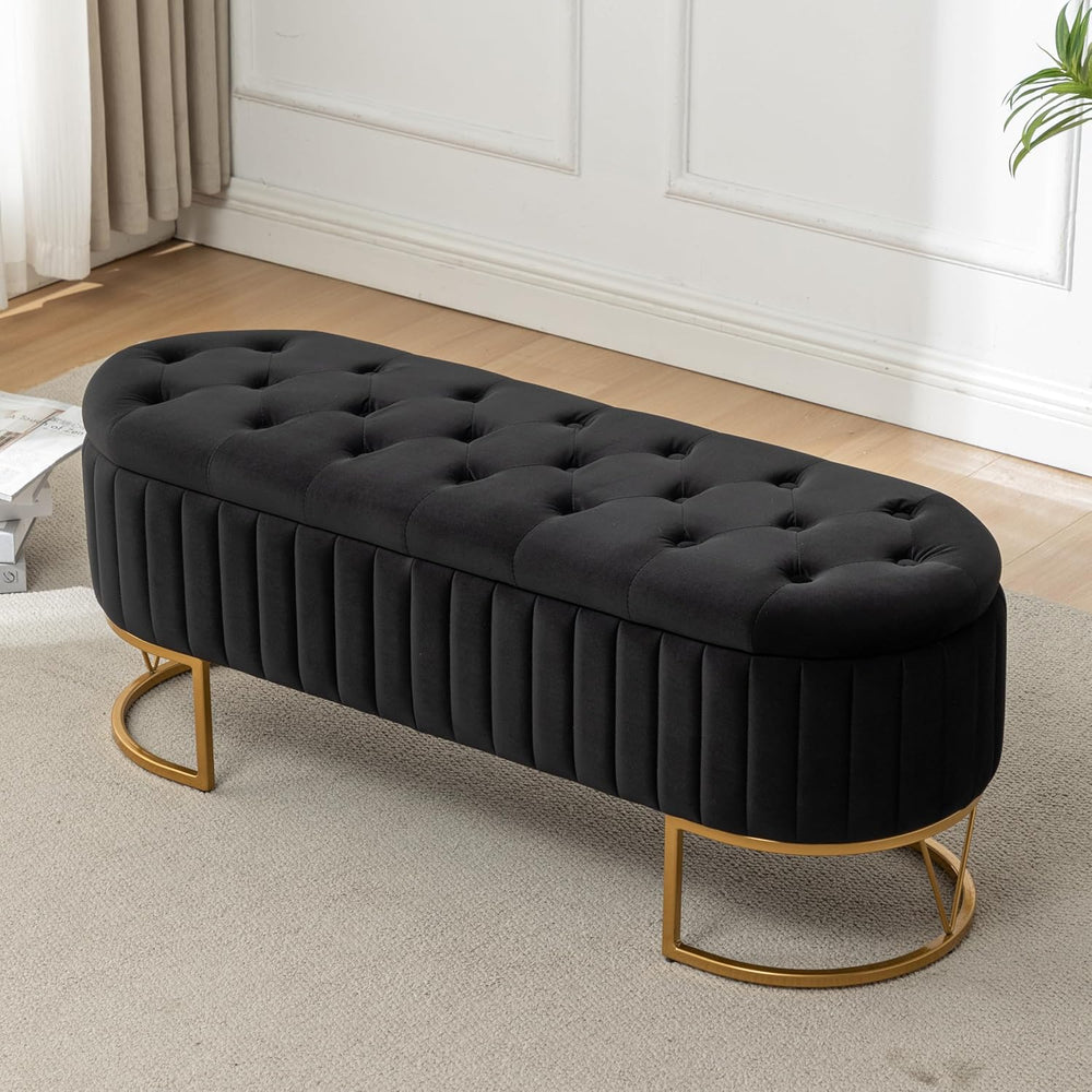 Black tufted bench with gold legs in a room setting