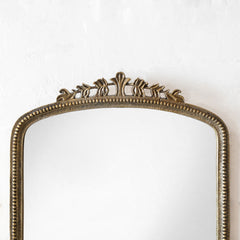 Decorative mirror with an ornate frame on a white background