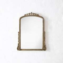 Decorative gold mirror on a white background