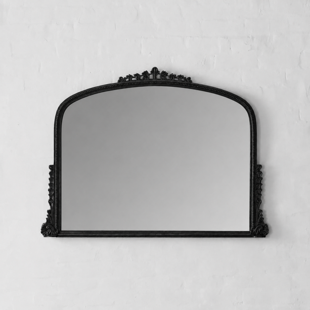 Black decorative mirror on a white wall