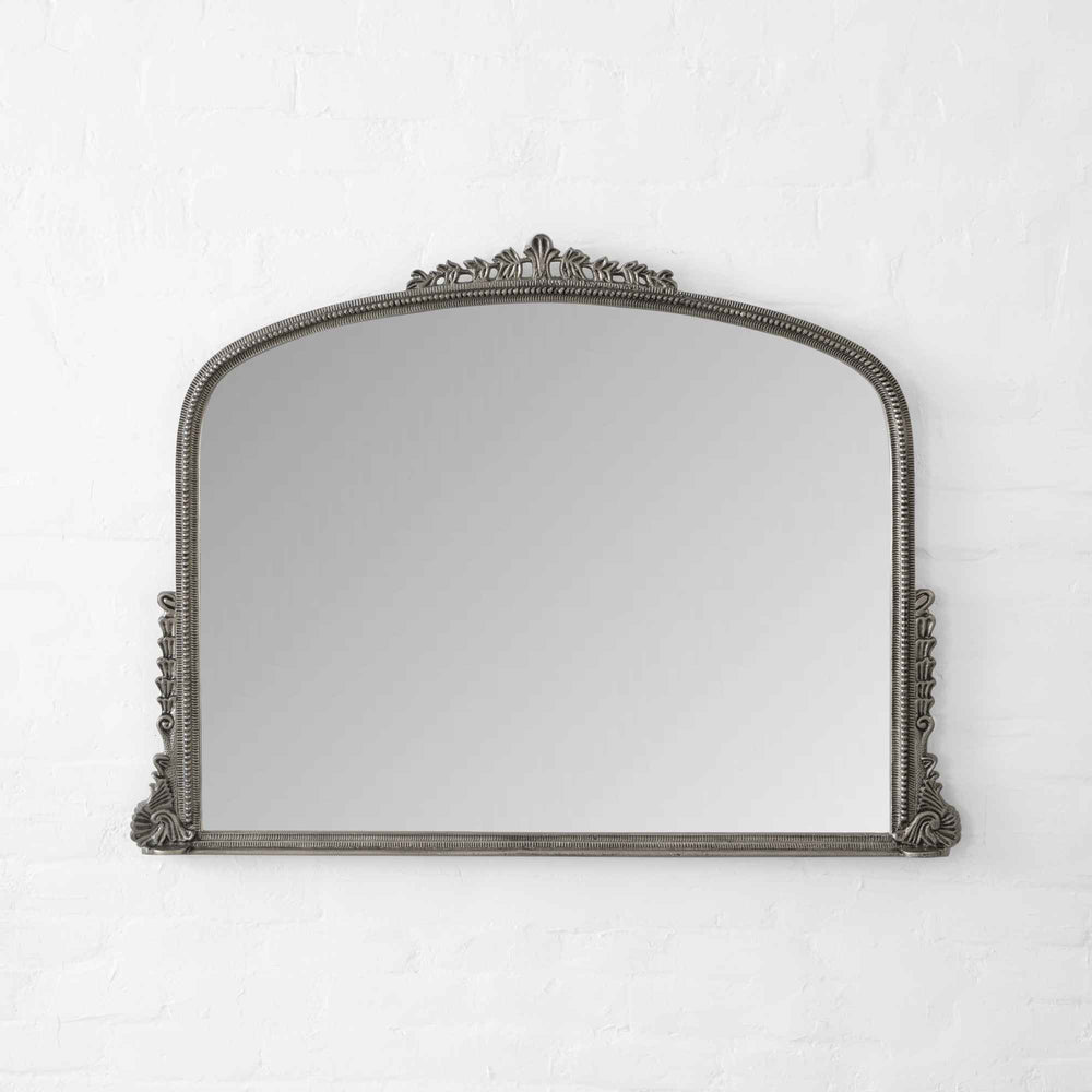 Decorative mirror with ornate frame on a white background