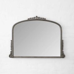Decorative mirror with ornate frame on a white background