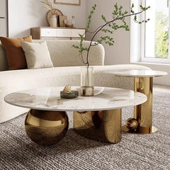 Modern coffee table with marble top and gold legs in a living room setting