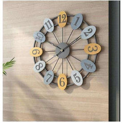 Decorative wall clock with colorful numbers on a wooden background