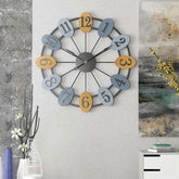 Decorative wall clock with colorful numbers on a gray wall.