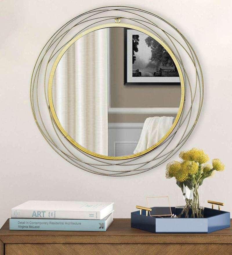 Round wall mirror in golden colour - All India Decor