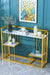 Gold console table with marble top against a teal wall with abstract art
