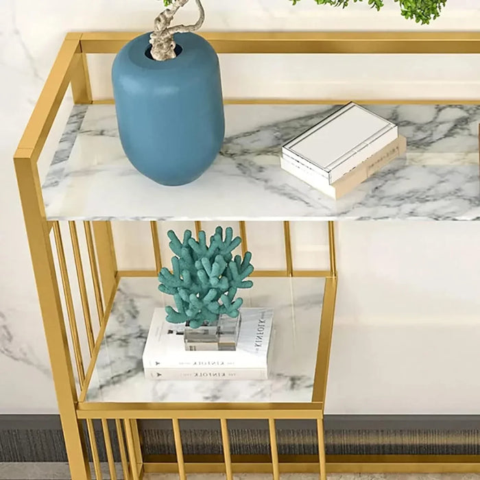 Gold-framed shelf with marble surface, blue vase, and decorative coral on a white background