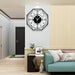 Modern 30 inch wall clock on a wall above a living room setup with a sofa and decor items.
