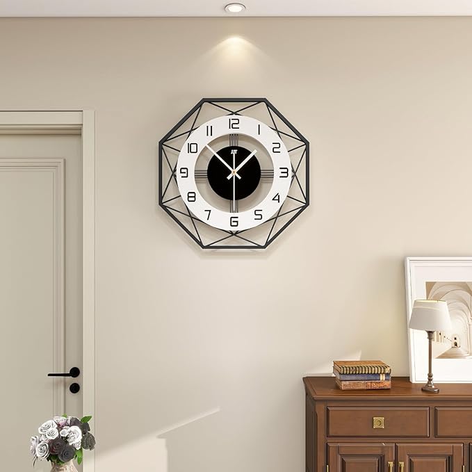 Geometric 30 inches wall clock on a beige wall with a wooden cabinet and lamp in the background.