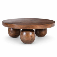 Wooden coffee table with spherical bases on a white background