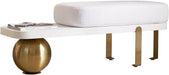 White ottoman with gold spherical base and metallic legs on a white background
