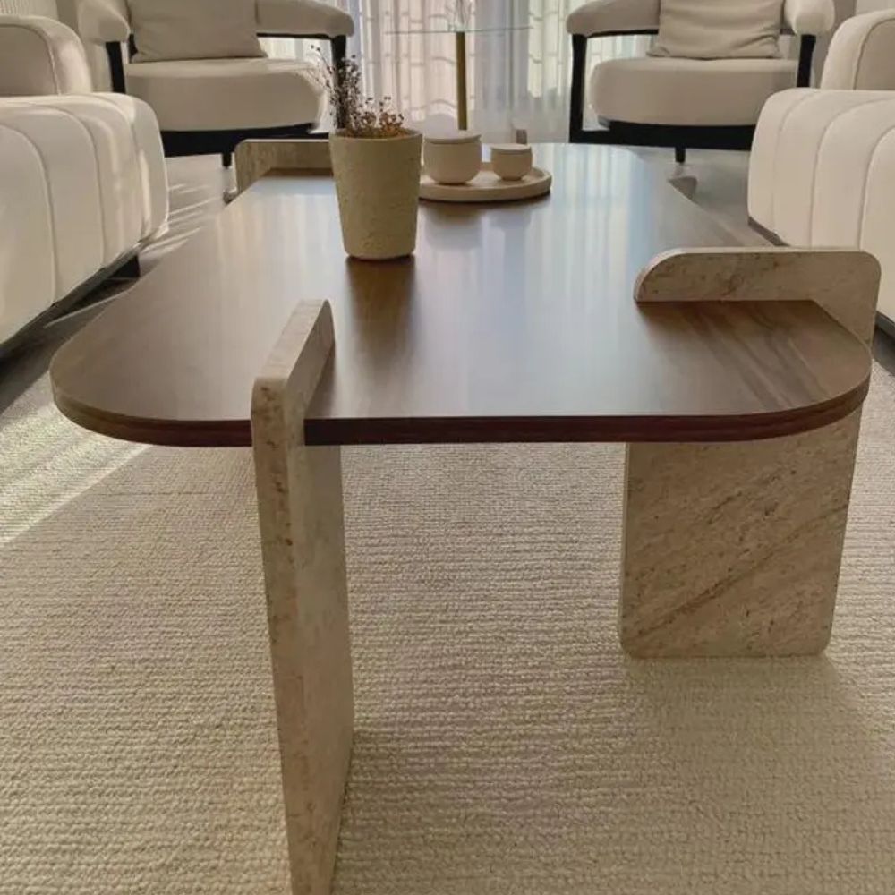 Wooden coffee table in a modern living room setting with neutral decor.