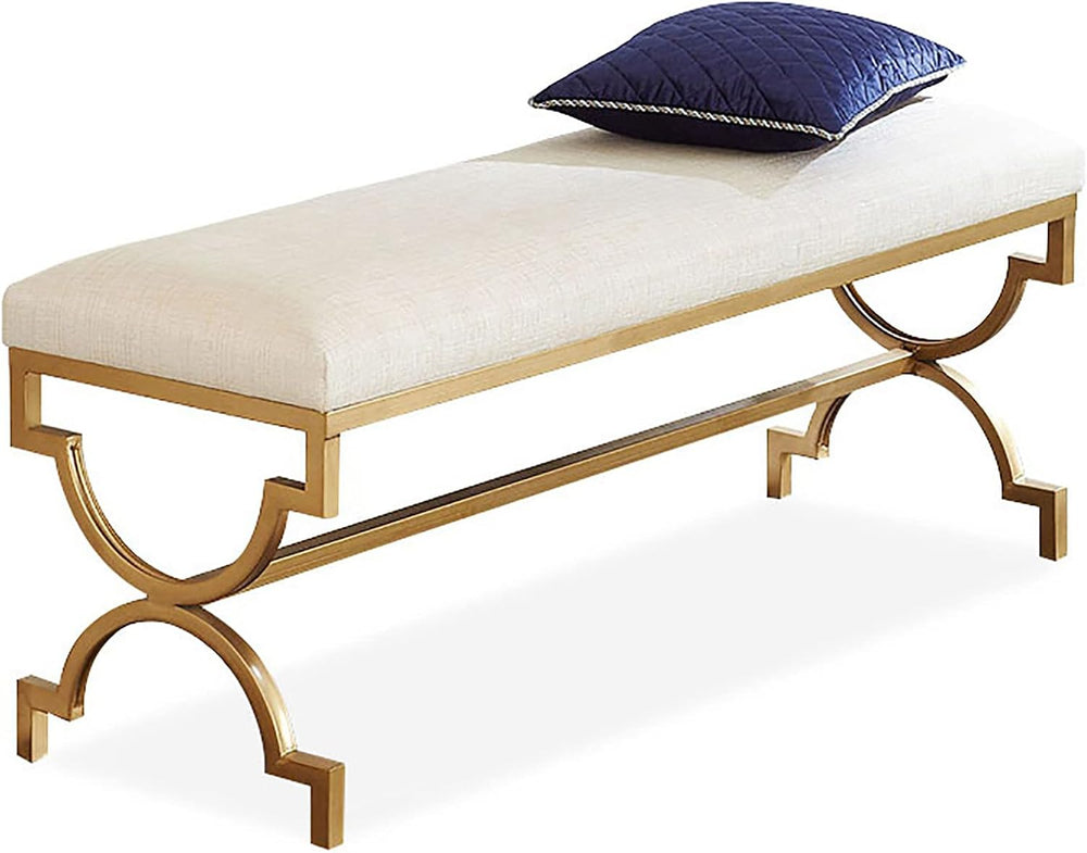 Gold bench with white cushion and blue pillow on a white background