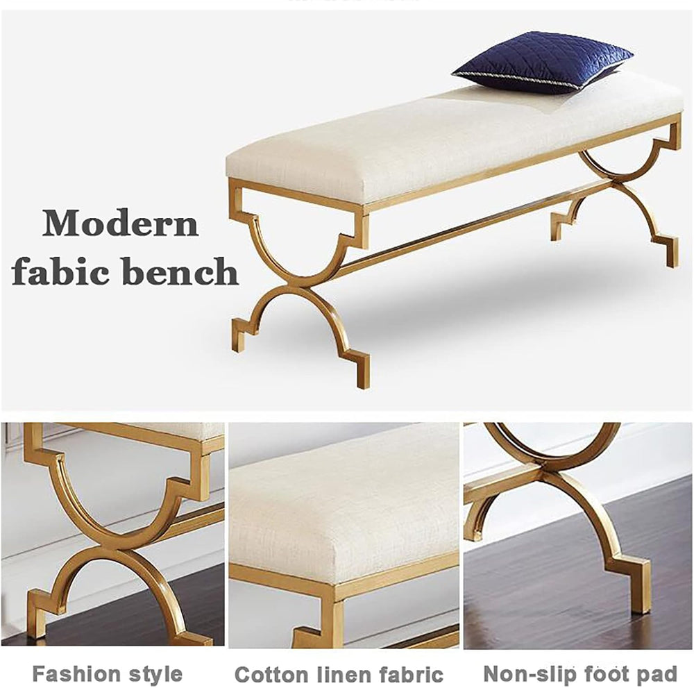 Modern fabric bench with gold frame and white cushion on a plain background