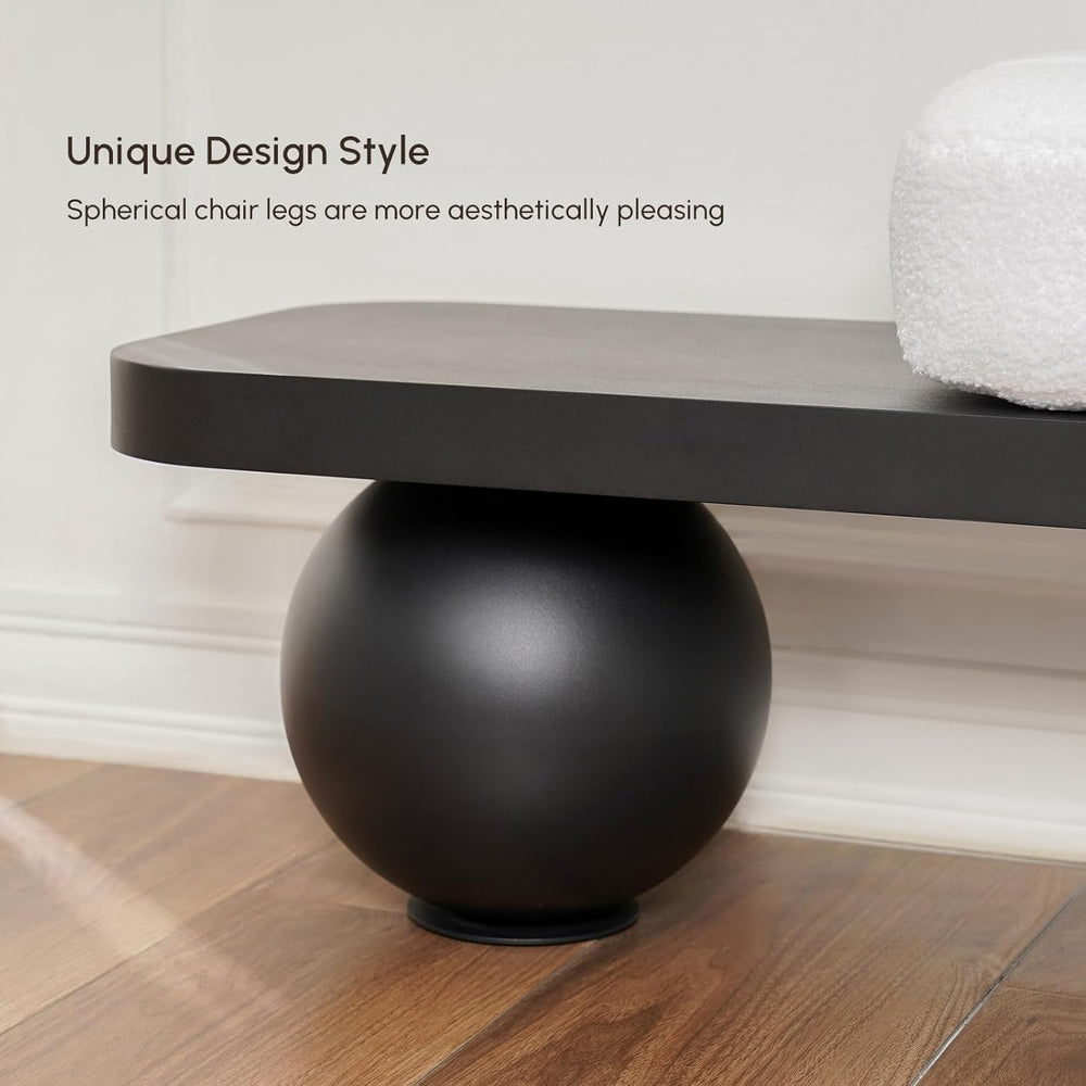 Modern chair with spherical black legs on a wooden floor