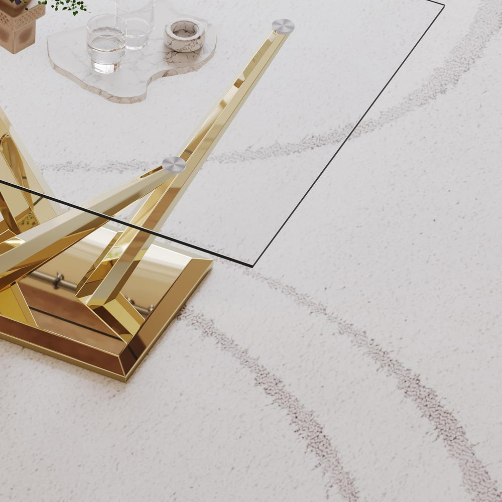 Gold coffee table with glass top on a light-colored floor
