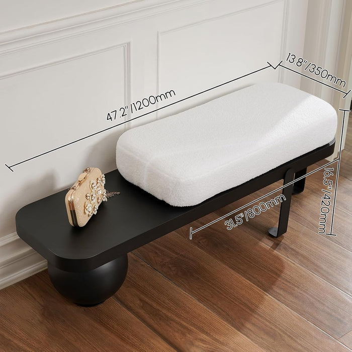 Black bench with white cushion and gold clutch, measurements indicated, on a wooden floor.