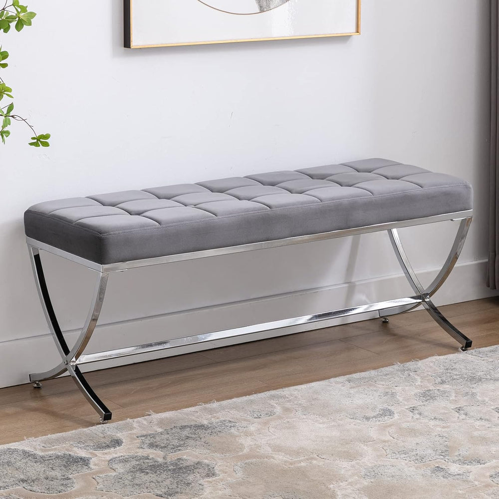 Gray tufted bench with chrome legs in a room setting