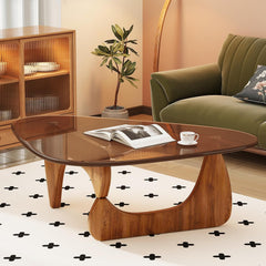 Wooden coffee table with a magazine and cup in a living room setting