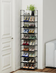 Tall black shoe rack with various shoes on a white wall background