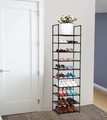 Tall black metal shoe rack with shoes on shelves against a white wall.