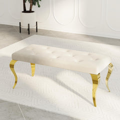 Beige tufted bench with gold legs in a modern interior setting