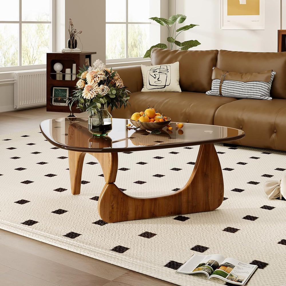 Living room with a brown sofa, wooden coffee table, and decorative items.