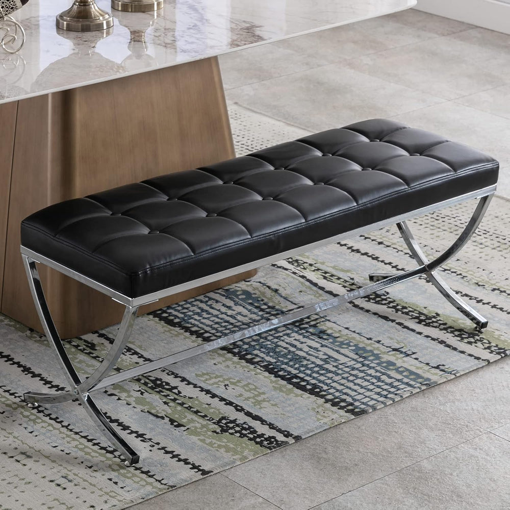 Black leather bench with metal legs on a patterned rug