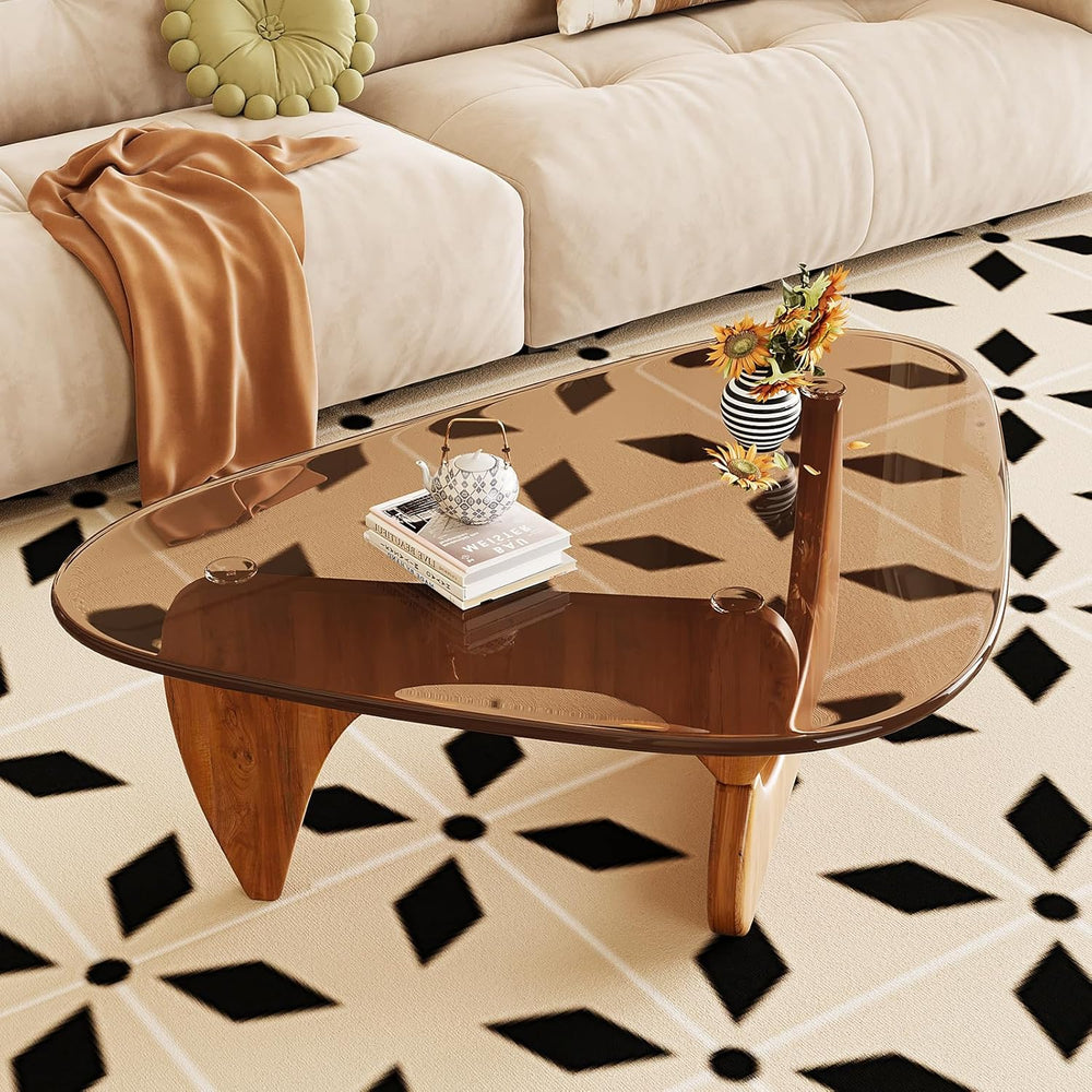 Glass coffee table with decorative items on a patterned floor