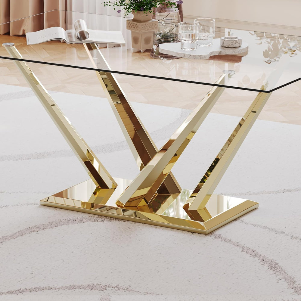 Glass dining table with gold metal legs on a white rug