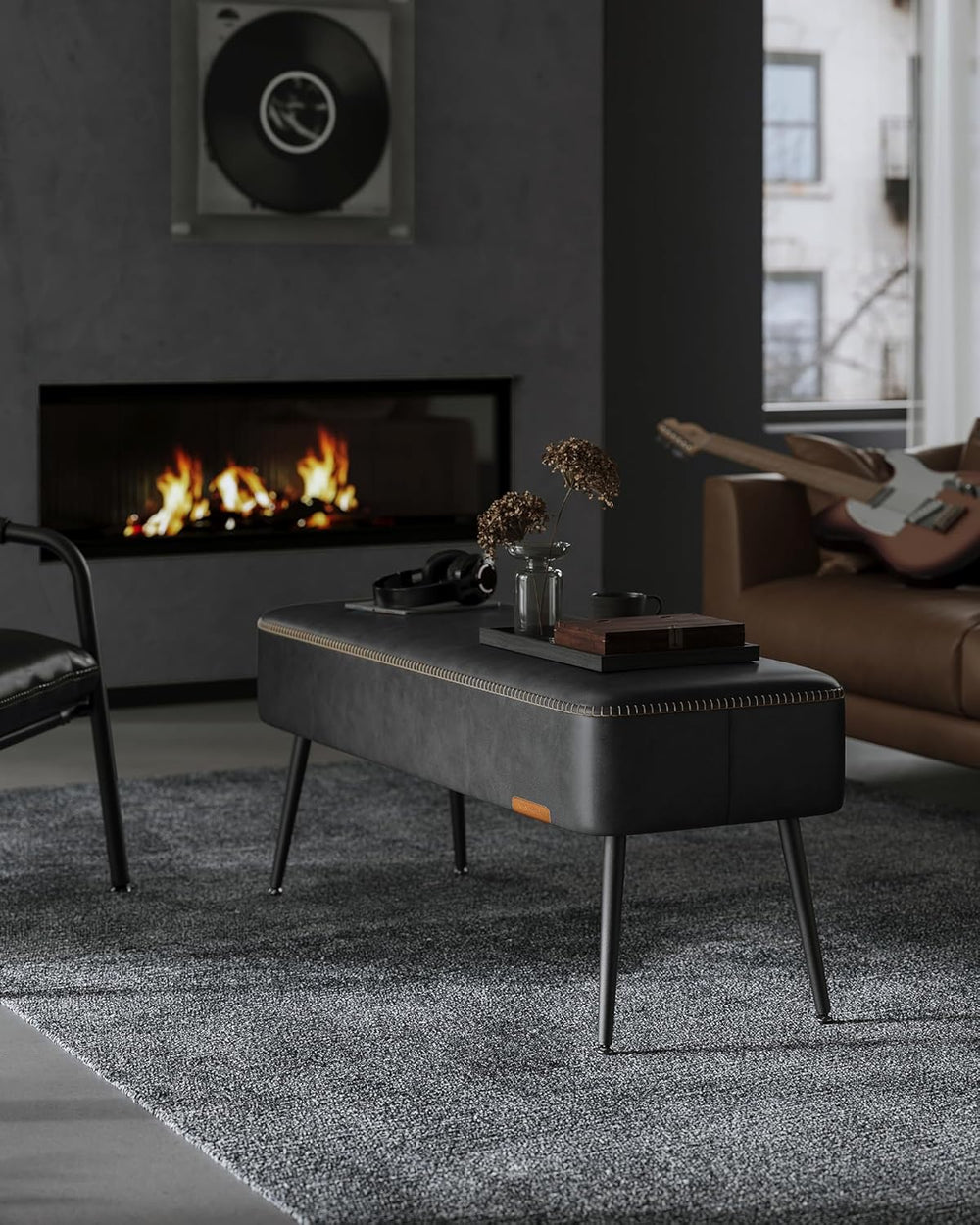 Modern living room with a coffee table, fireplace, and guitar.