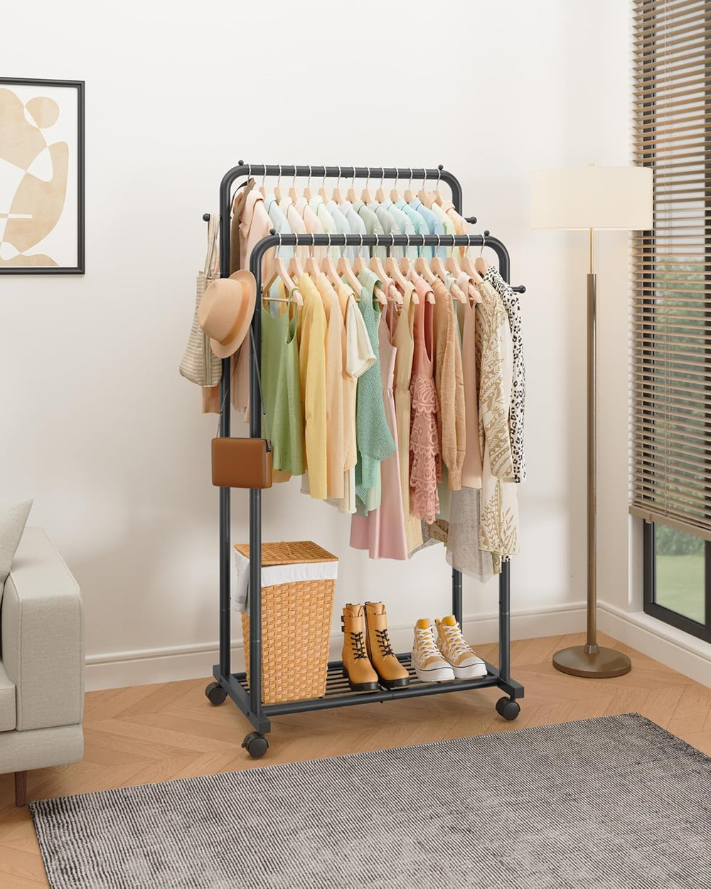 Clothing rack with clothes and shoes in a room with a lamp and window.