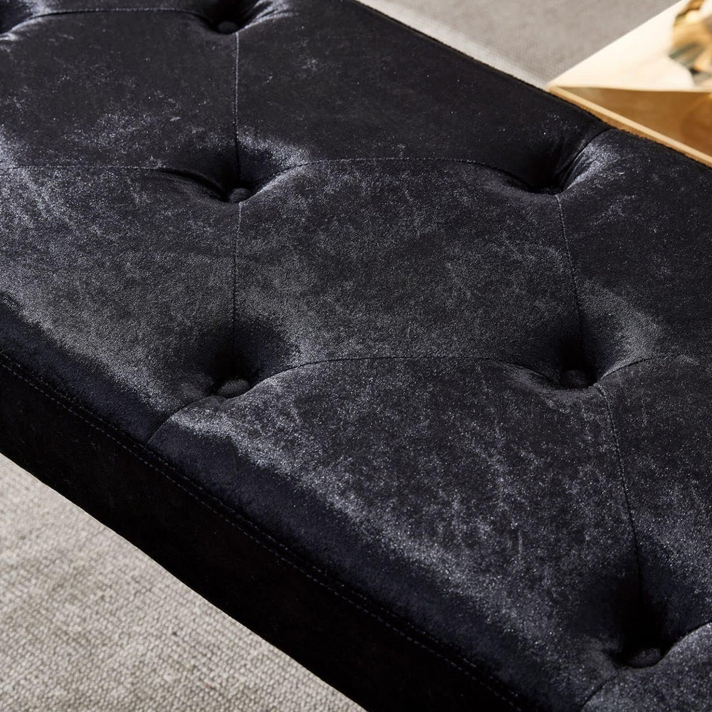 Close-up of a black tufted bench with a textured surface.