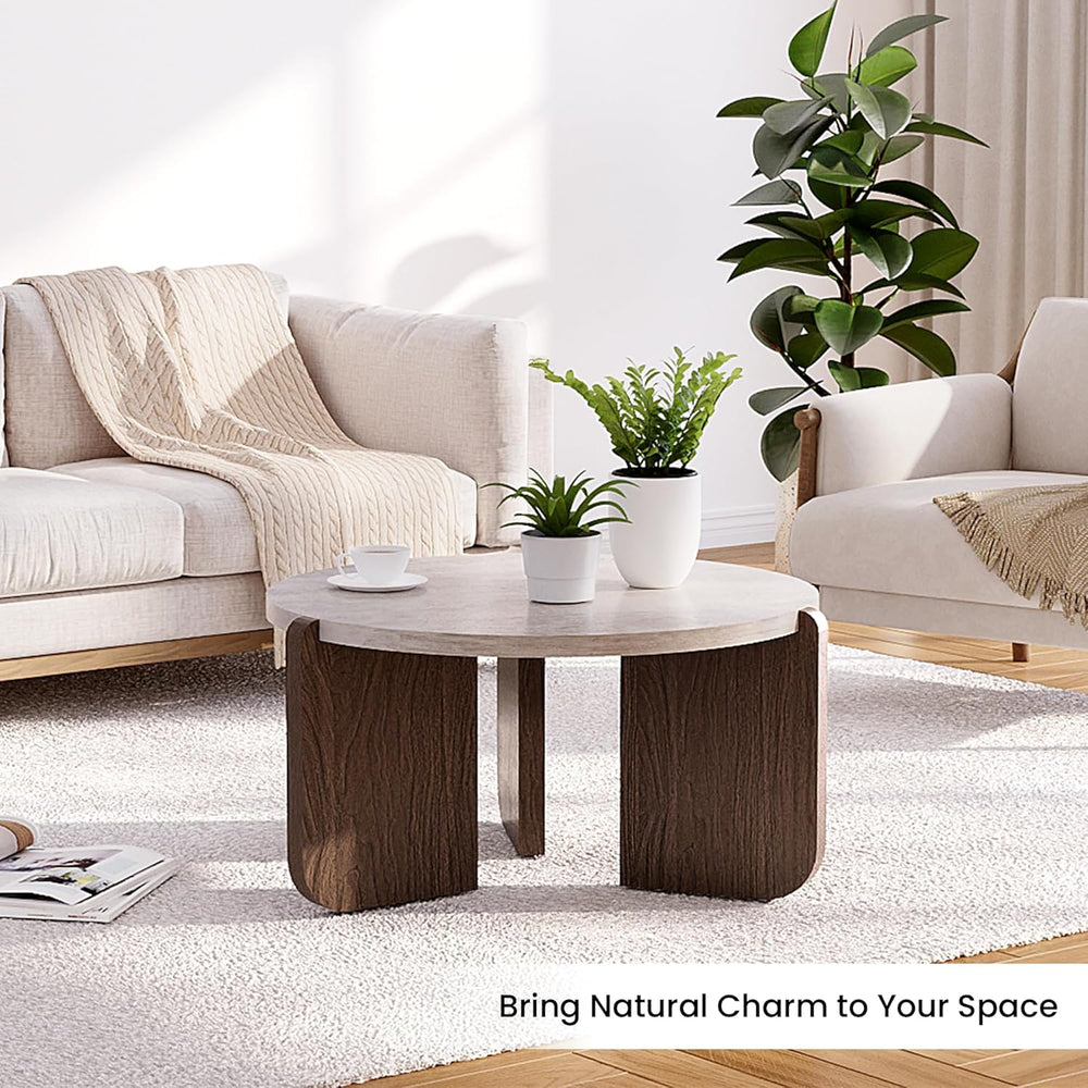 Modern living room with a wooden coffee table, beige sofa, and potted plants.