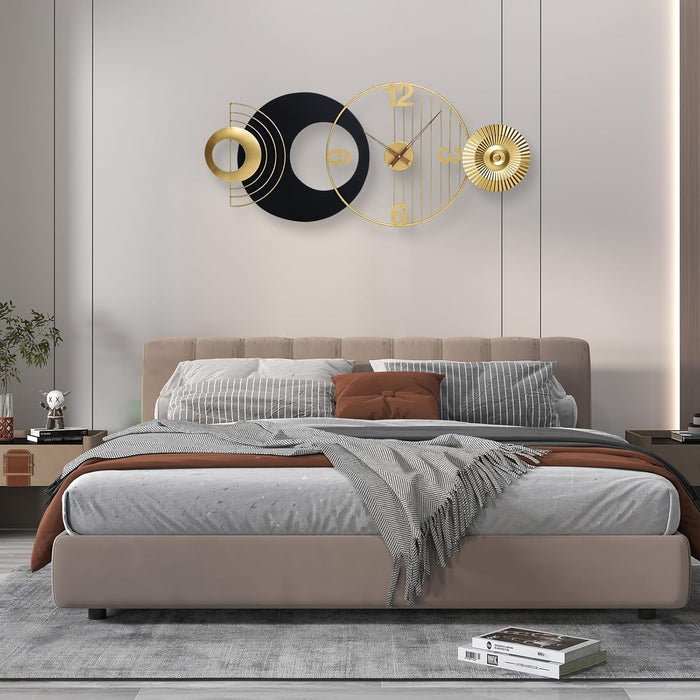 Modern bedroom with a bed and decorative wall clocks.