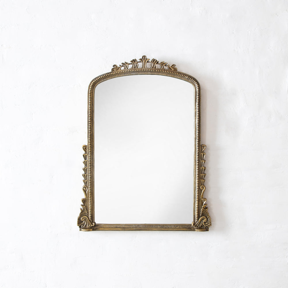 Decorative gold mirror on a white background
