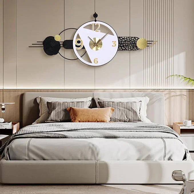 Decorative wall clock above a bed in a bedroom setting
