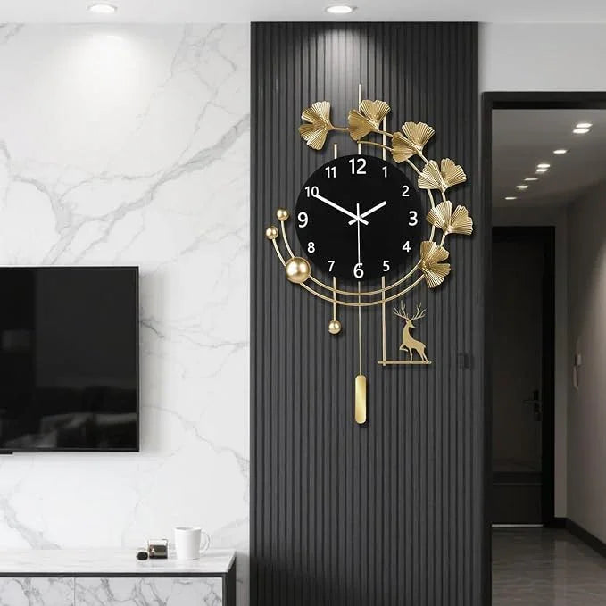 Decorative wall clock with gold leaves and deer design on a black panel in a modern interior setting.