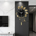 Decorative wall clock with gold leaves and deer design on a black panel in a modern interior setting.