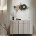 Modern interior design with a white cabinet, decorative clock, and wall lights.