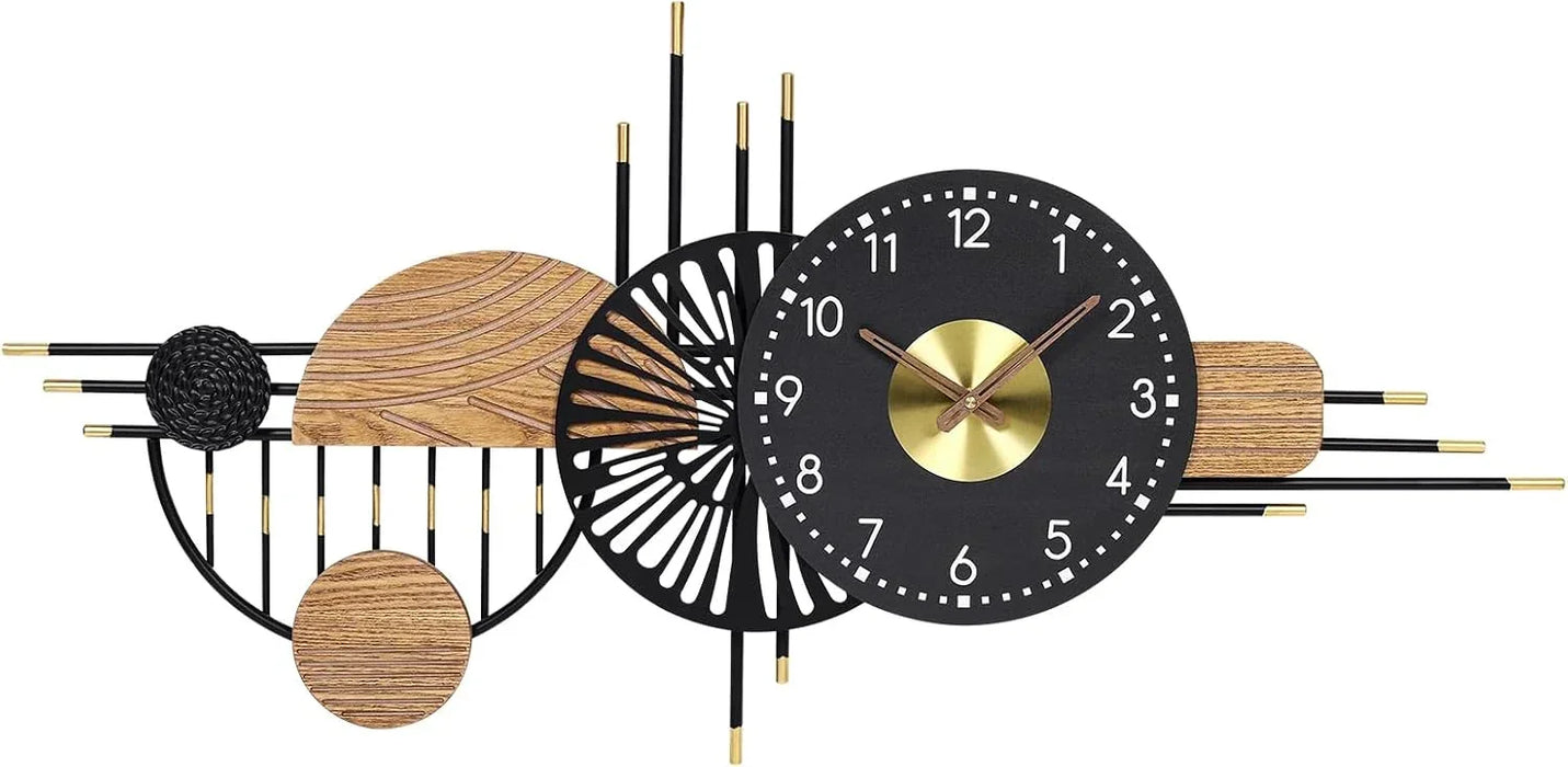 Decorative wall clock with black and gold design on a white background